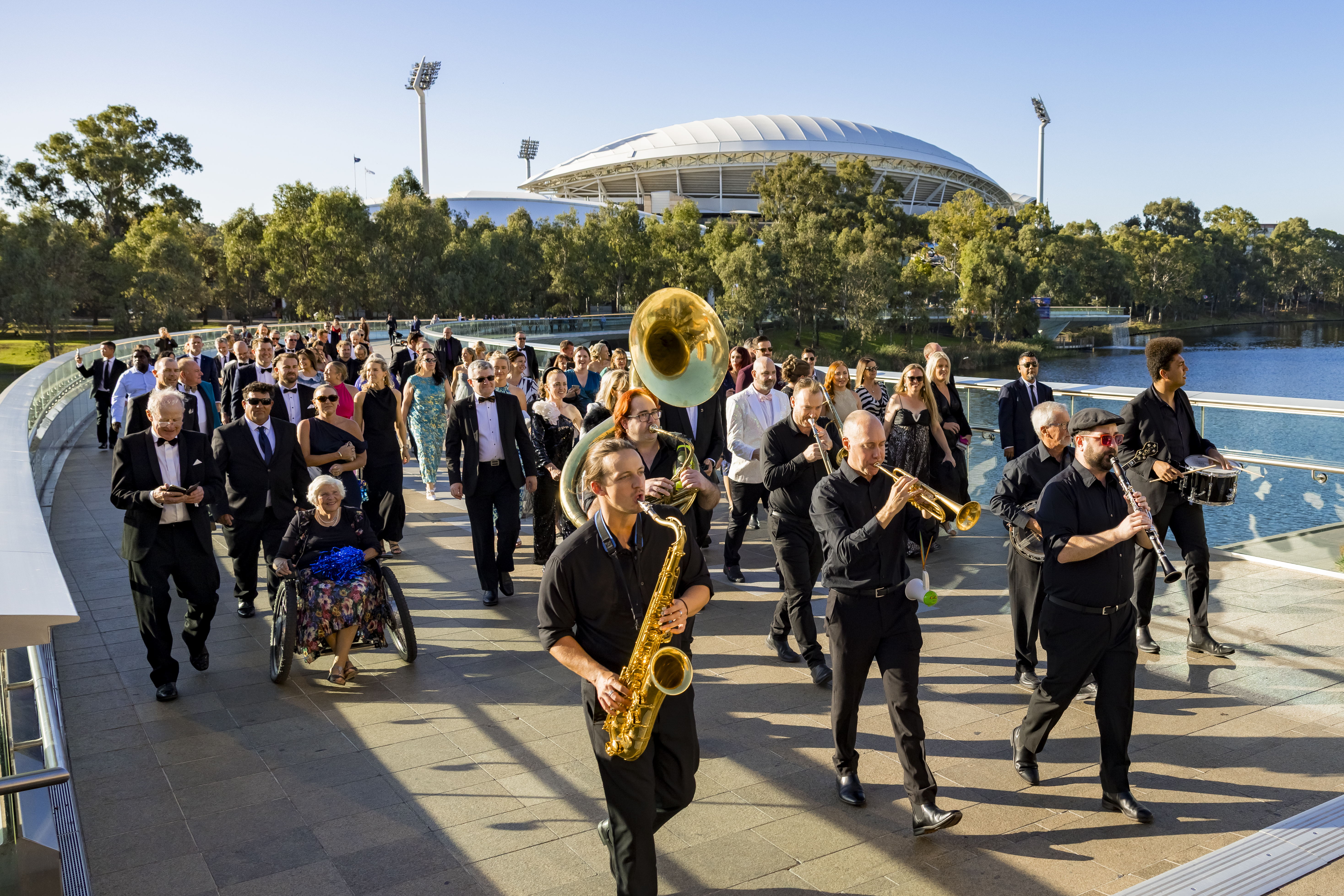 Atlantic Street Band lead a musical procession of delegates from Adelaide Oval across the bridge to Adelaide Convention Centre
