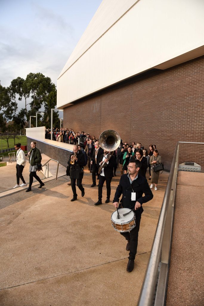 Atlantic Street Band rounding the corner of Space Theatre leading TiCSA delegates from Adelaide Festival Centre to The Guardsman