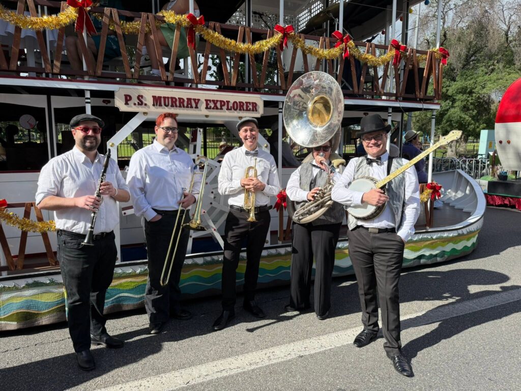 Atlantic Street Band members prepare to play on the P.S. Murray Explorer float with Keith Conlan at the Adelaide Christmas Pageant